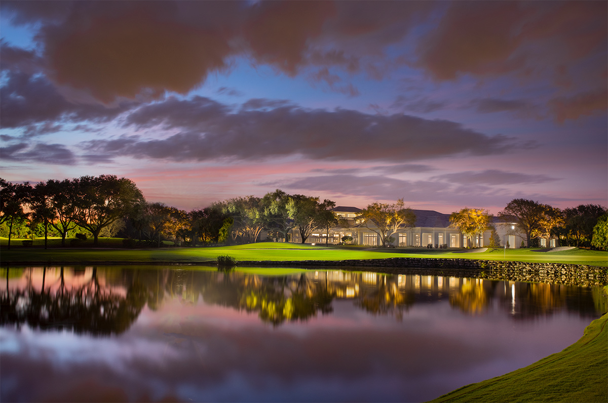 High Ridge Country Club Boynton Beach clubhouse lake view at dusk.