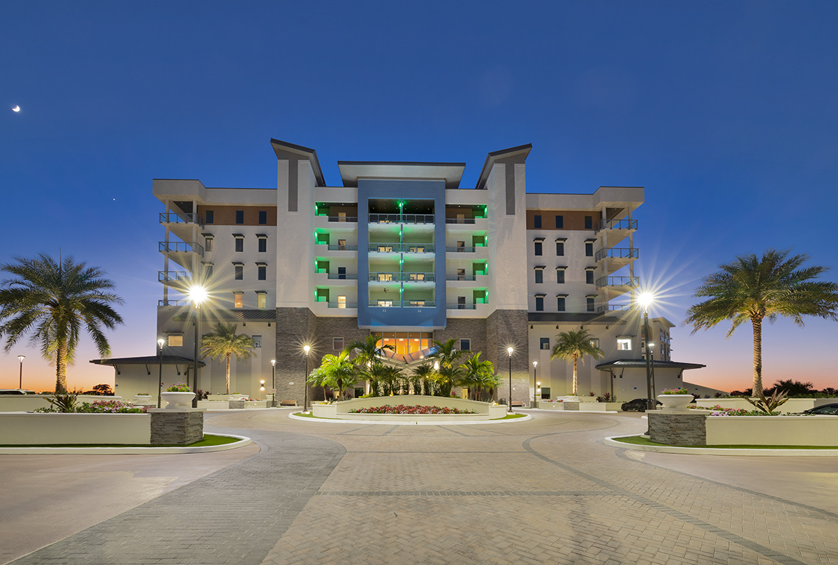 Architectural dusk view of Moorings Grand Lake Clubhouse - Naples, FL.