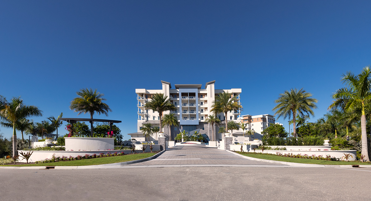 Architectural landscape view of Moorings Grand Lake Clubhouse - Naples, FL.