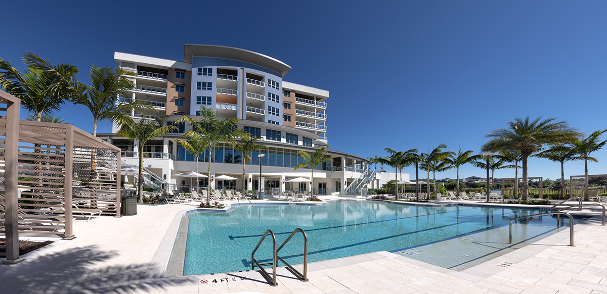 Architectural poolside view of Moorings Grand Lake Clubhouse - Naples, FL.