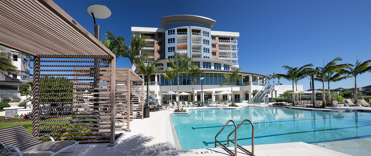 Architectural poolside view of Moorings Grand Lake Clubhouse - Naples, FL.