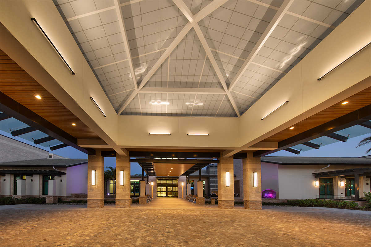 Architectural dusk view of Moorings Park Clubhouse in Naples, FL