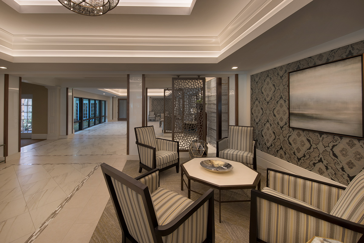 Interior design view of Moorings Park Clubhouse guest lounge in Naples, FL.