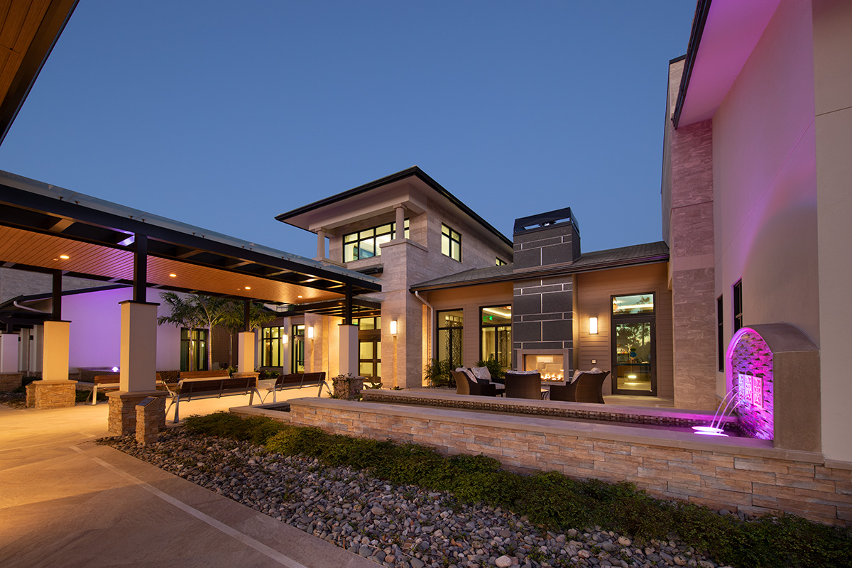 Architectural dusk view of Moorings Park Clubhouse in Naples, FL