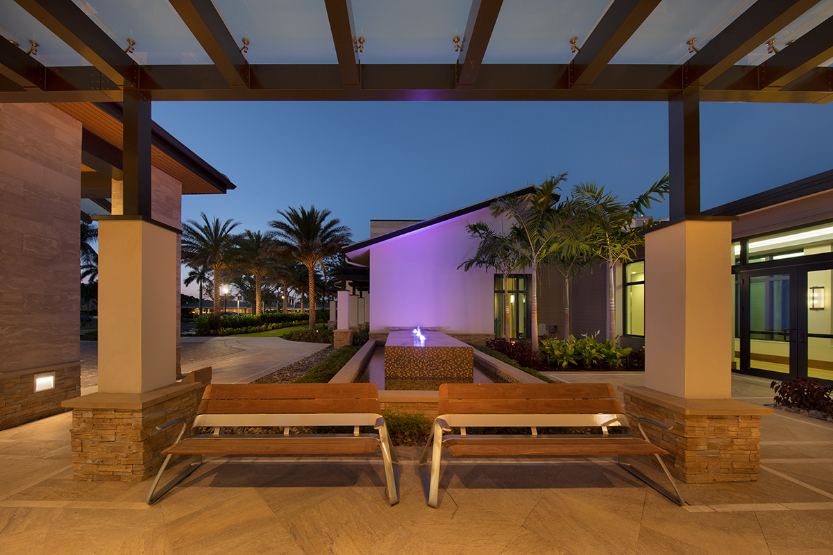 Architectural dusk view of Moorings Park Clubhouse fountain in Naples, FL