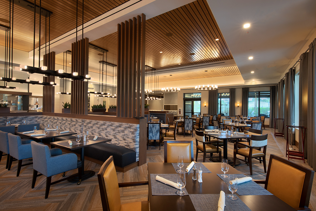 Interior design view of Moorings Park Clubhouse dining in Naples, FL.