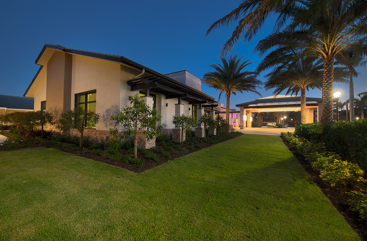 Architectural dusk view of Moorings Park Clubhouse in Naples, FL