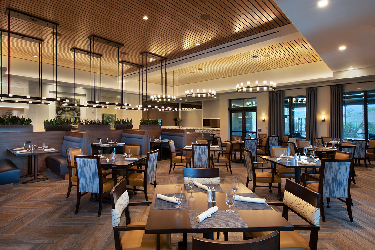 Interior design view of Moorings Park Clubhouse dining in Naples, FL.