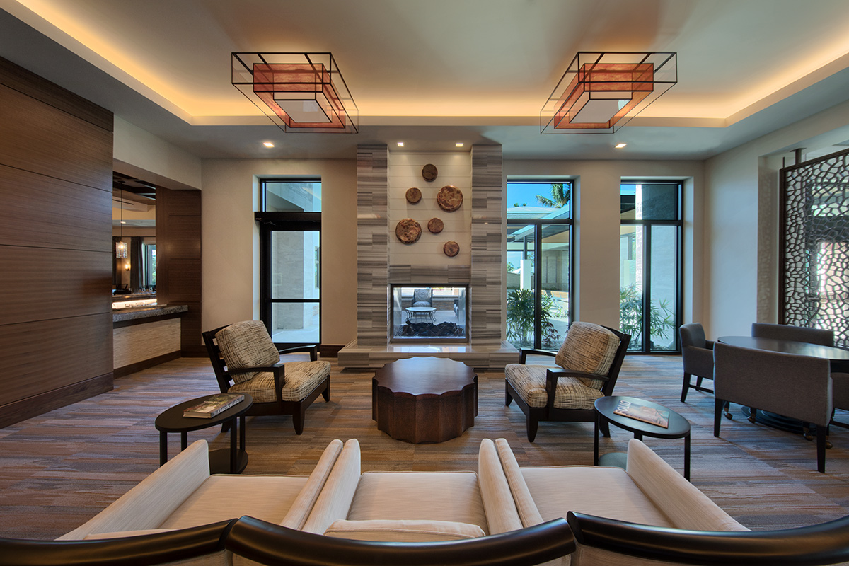Interior design view of Moorings Park Clubhouse guest lounge in Naples, FL.