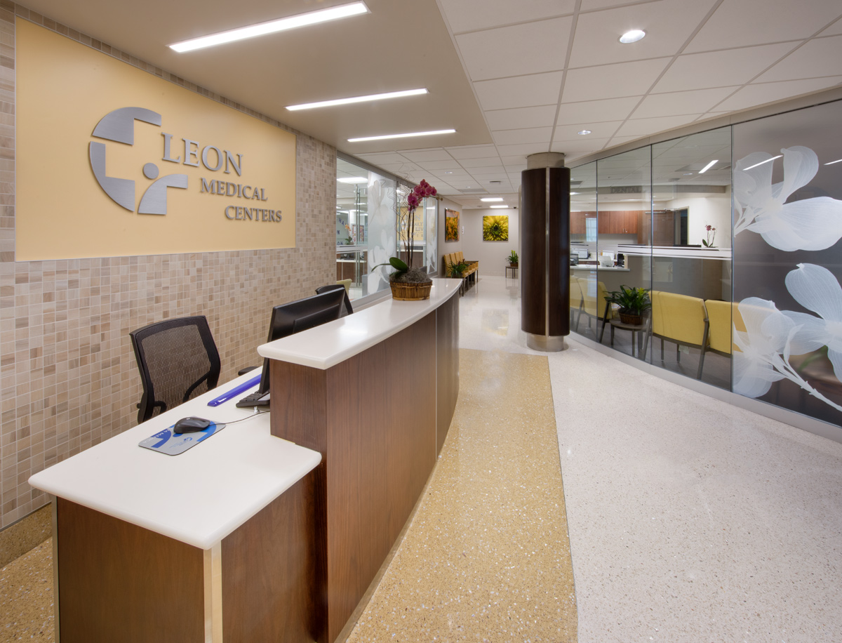 Interior design view of a primary care reception at the Leon Medical Center in Kendall, FL.