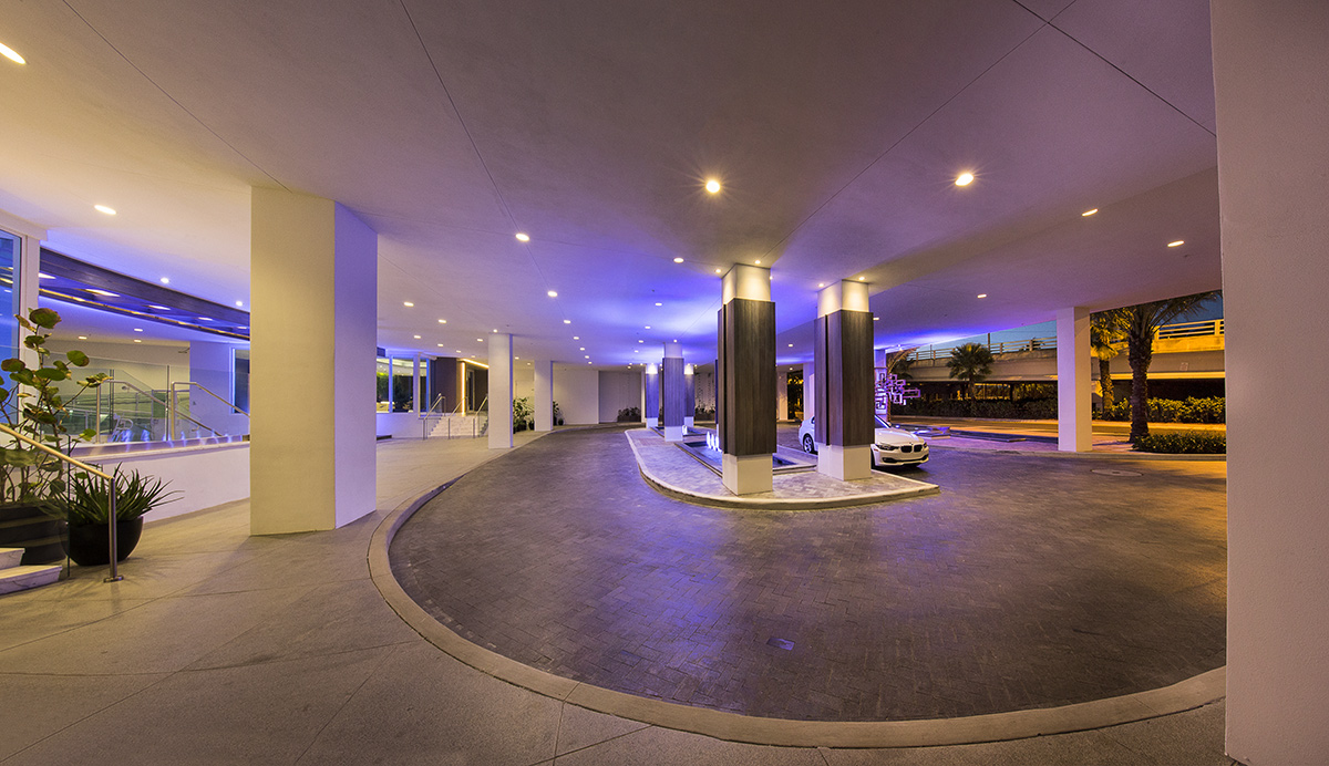 Architectiural dusk view of the entrance at the 400 Sunny Isles condo.