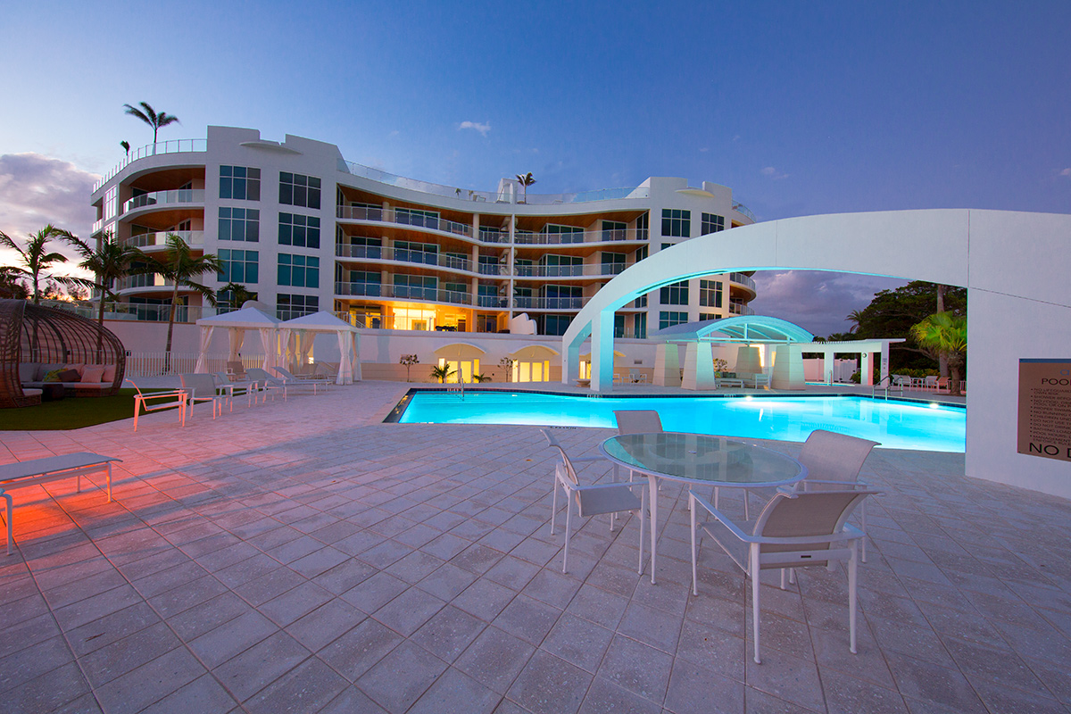 Architectural pool dusk view at Aria Luxury Condos Longboat Key - Sarasota, FL.