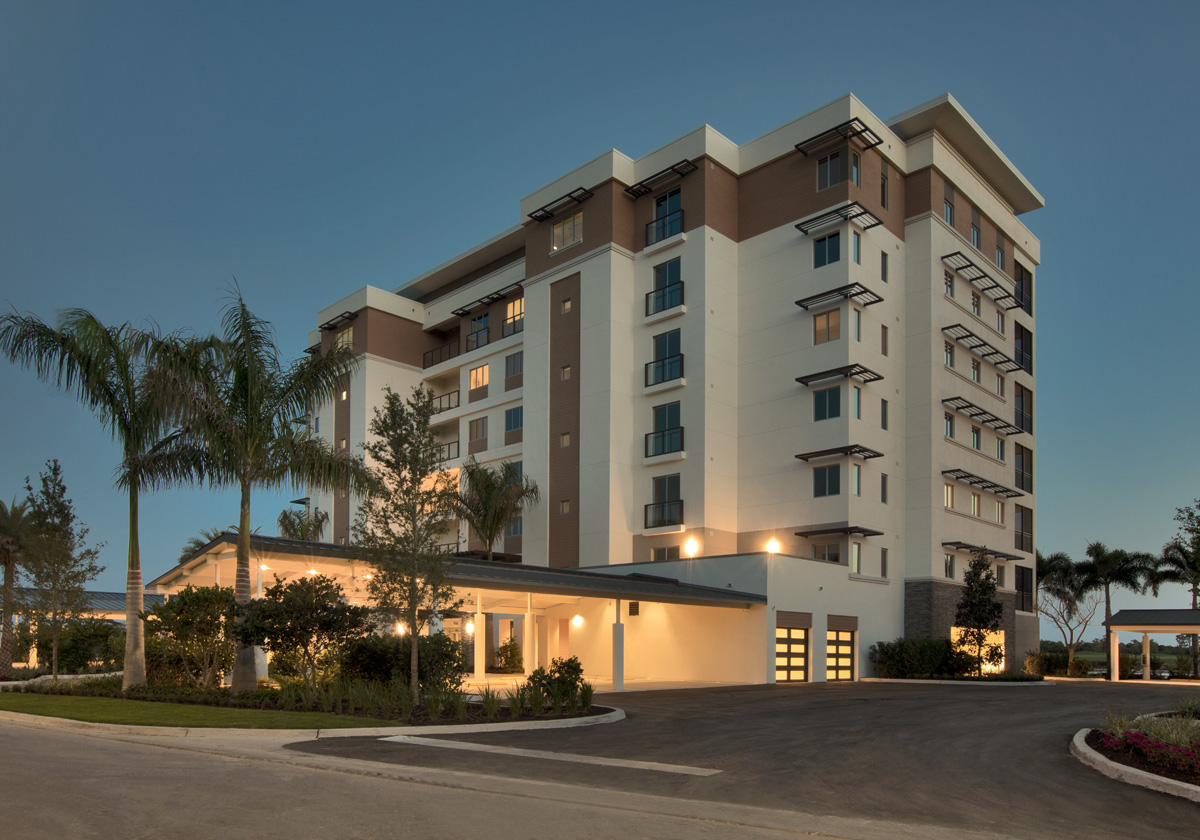 Architectural dusk view of Moorings Park Grande Lake Senior Living in Naples, FL